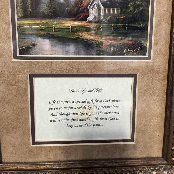 Framed landscape print above a memorial poem plaque