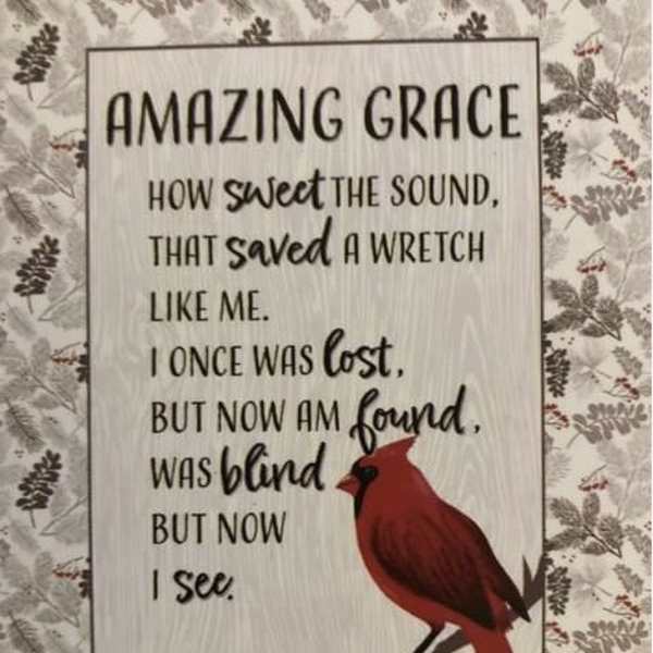 Decorative sign with a cardinal and religious text