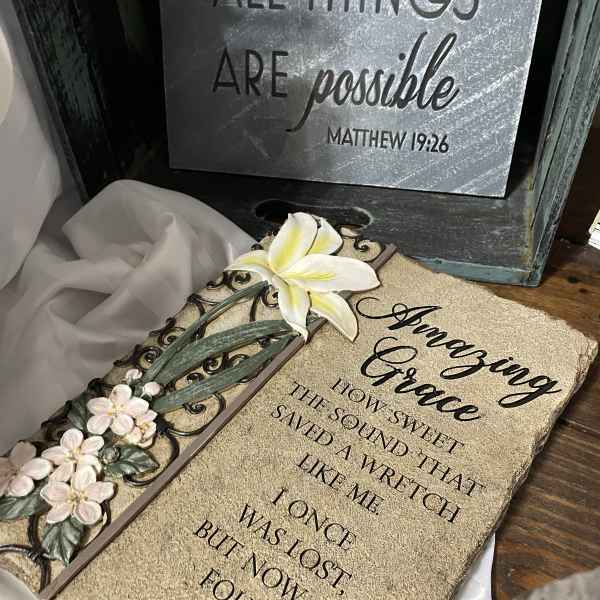 Decorative plaque with white flowers and a Bible verse