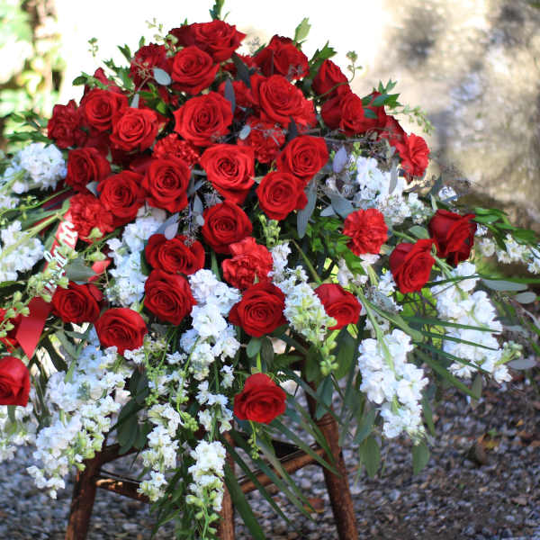 Large arrangement of red roses with white flowers outdoors