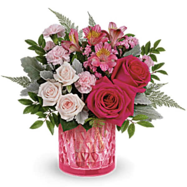 Pink and white rose bouquet in a pink glass vase