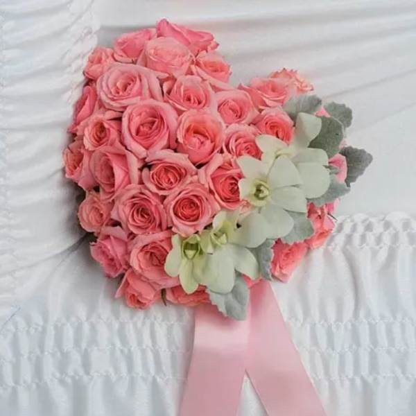 Pink rose bouquet with pale green orchids and a pink ribbon