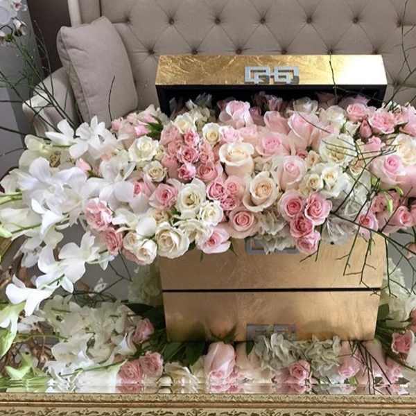Large pastel floral arrangement with pink and white roses in a gold box