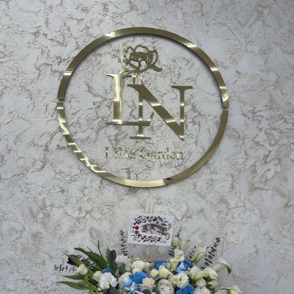 Blue and white rose arrangement with lilies and a teddy bear in a box