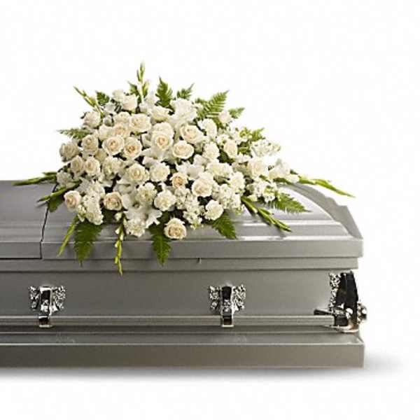 White floral spray on a gray casket