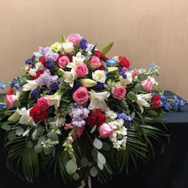 Large mixed floral arrangement with pink, white, red, and blue flowers