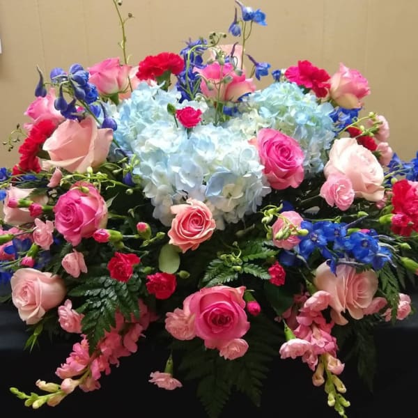 Mixed bouquet with pink roses, blue hydrangeas, and blue flowers