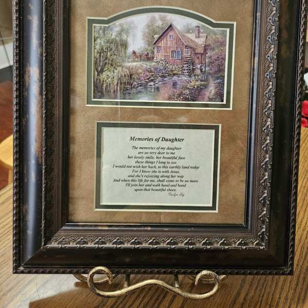 Framed memorial plaque with a countryside scene and poem
