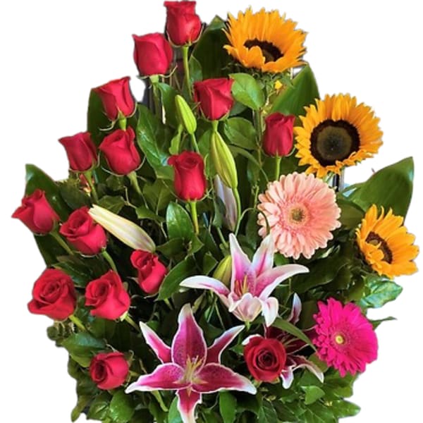 Mixed bouquet of red roses, sunflowers, lilies, and pink gerbera daisies in a vase