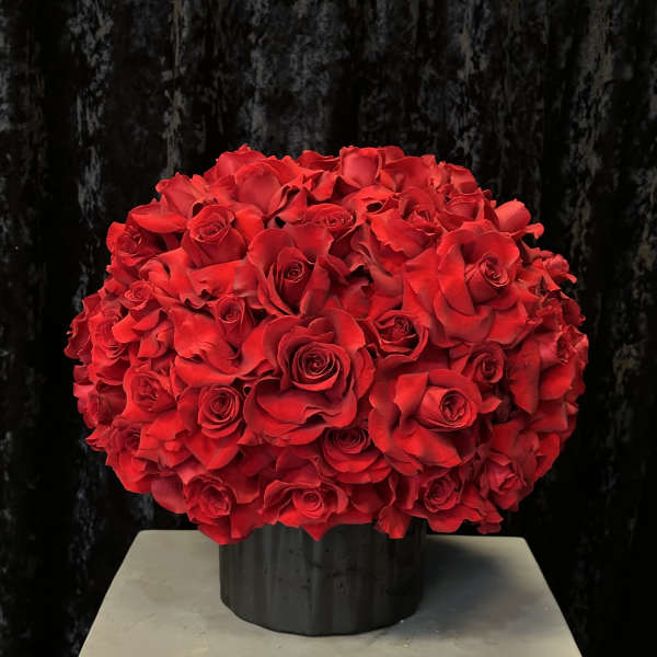 Large bouquet of red roses in a black vase