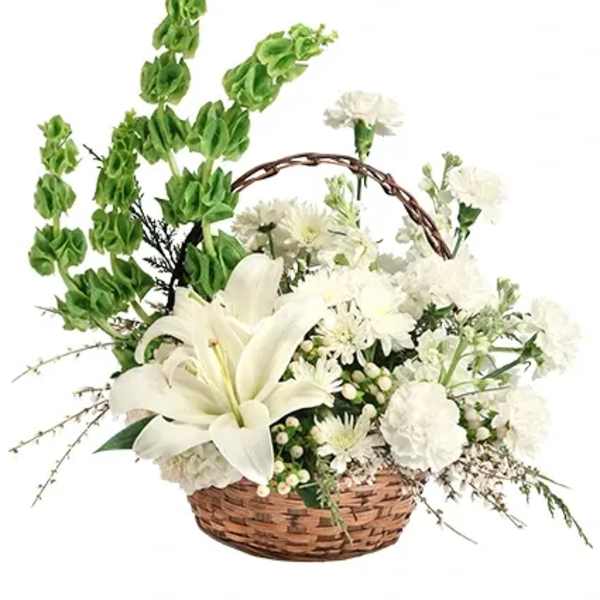 White lilies and chrysanthemums in a wicker basket with tall green spikes