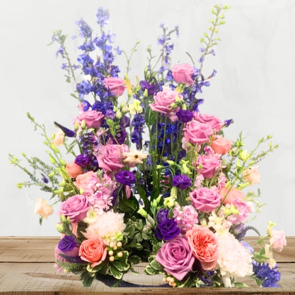 Tall mixed bouquet of pink, purple, and blue flowers