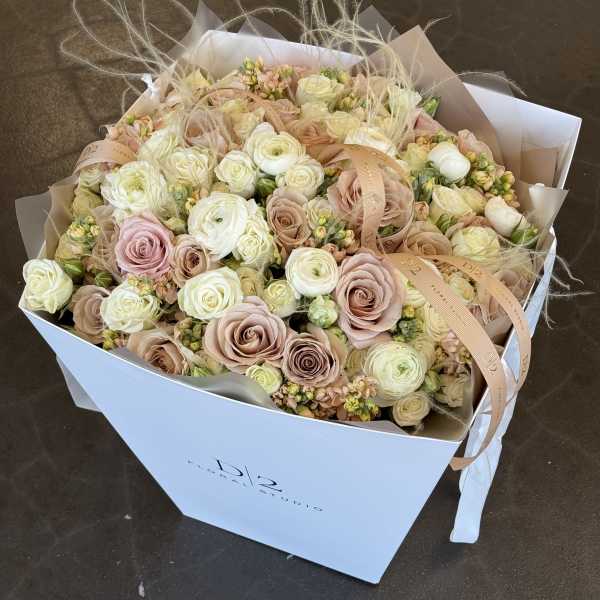 Bouquet of blush and cream roses in a white box