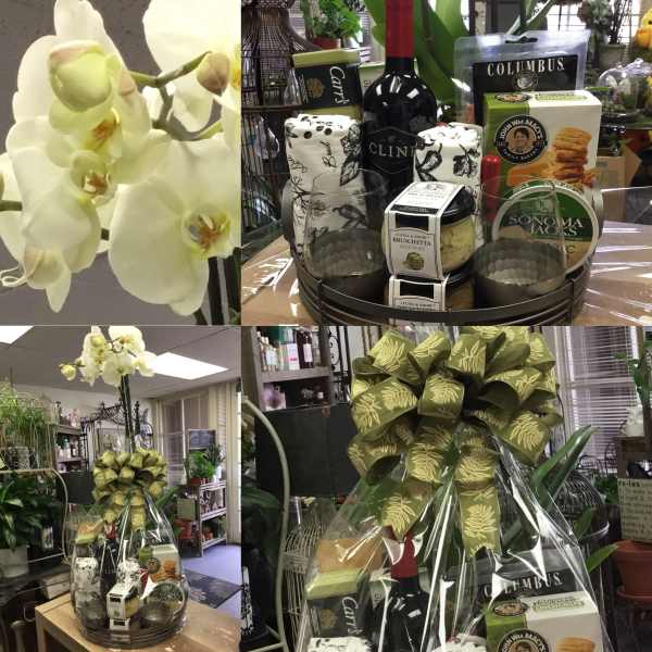 Gift basket with wine, snacks, and a large orchid stem