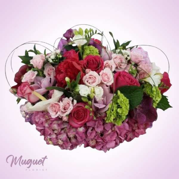 Mixed pink and red rose bouquet with hydrangeas and green accents