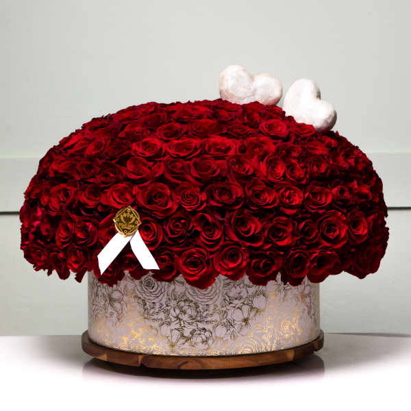 Large dome of red roses in a decorative round box with white heart toppers