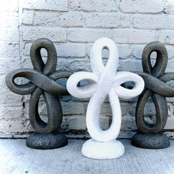 Three decorative looped sculptures in black and white