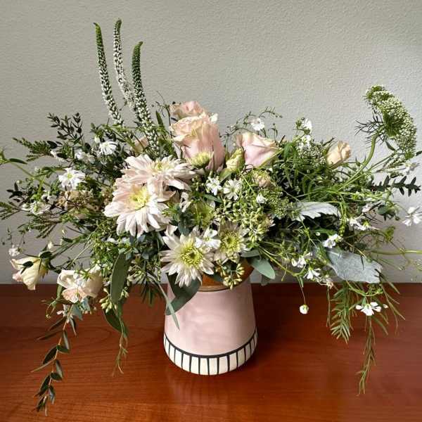 Loose pastel bouquet in a pink ceramic vase