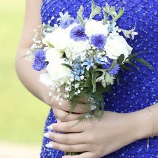 Bride holding a white and blue bouquet