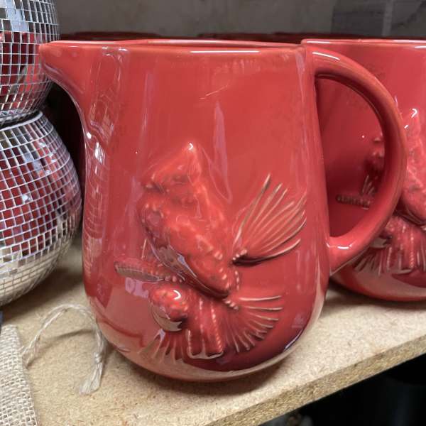 Red ceramic mug with an embossed fish design