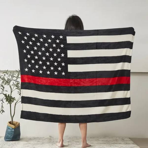 Person holding a large black, white, and red American flag blanket
