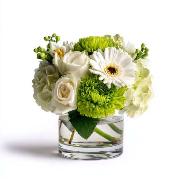 White and green bouquet in a clear glass vase