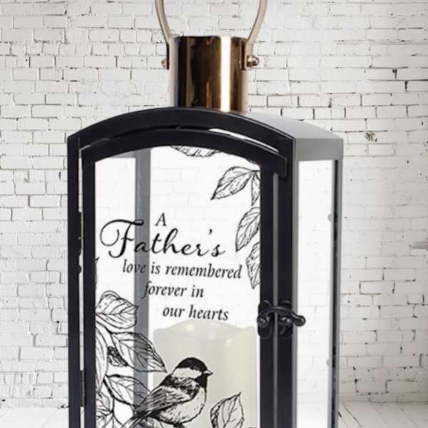 Black lantern with a memorial candle and father tribute text