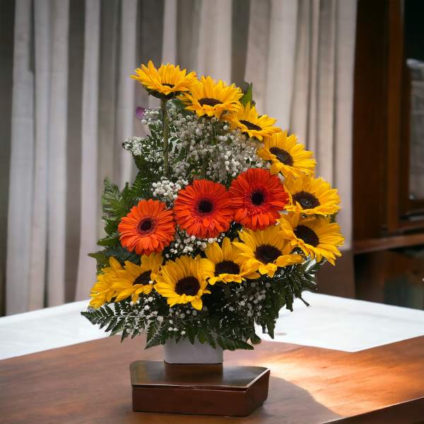 Sunflowers and orange gerbera daisies in a white vase