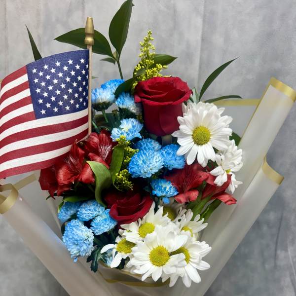 Bouquet of red roses, blue and white daisies, and an American flag