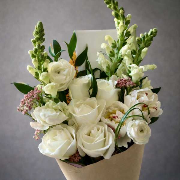White rose bouquet with snapdragons and pink filler flowers