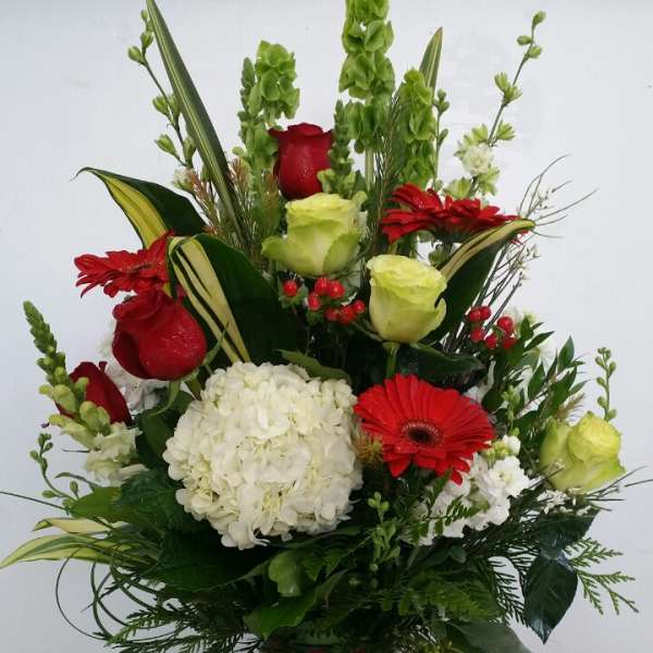 Red and white floral arrangement in a patterned vase