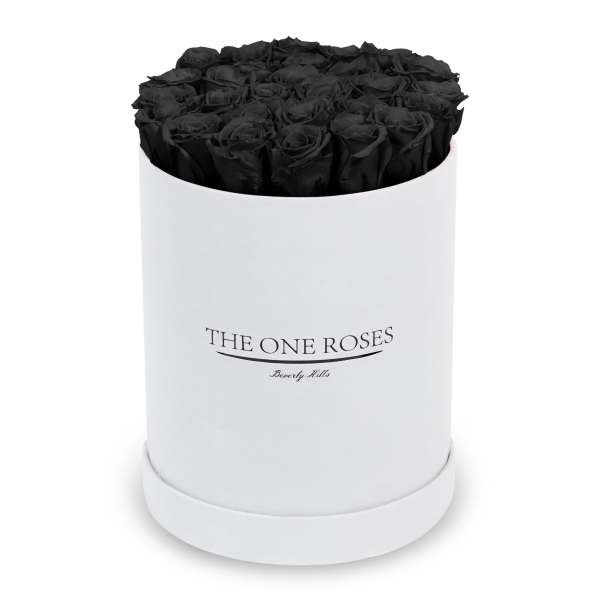 Black roses arranged in a white round box
