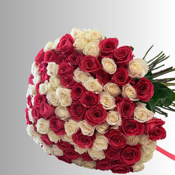 Large bouquet of red and cream roses tied with a ribbon