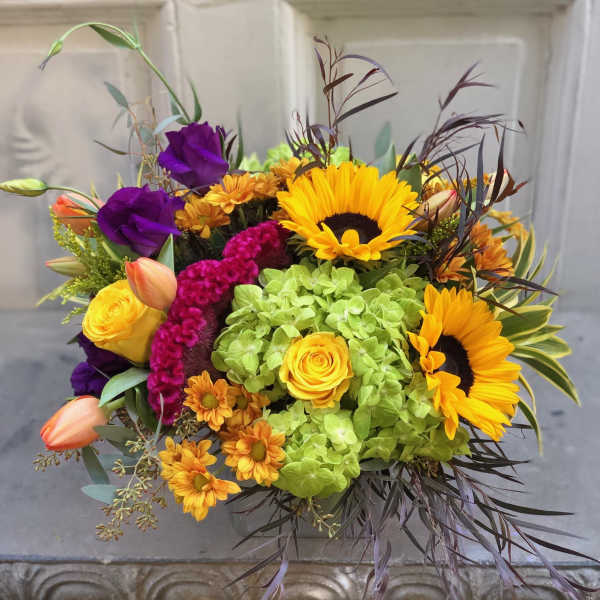 Bright mixed bouquet with sunflowers, roses, and purple blooms