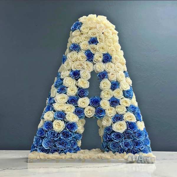 Large letter A covered in white and blue roses