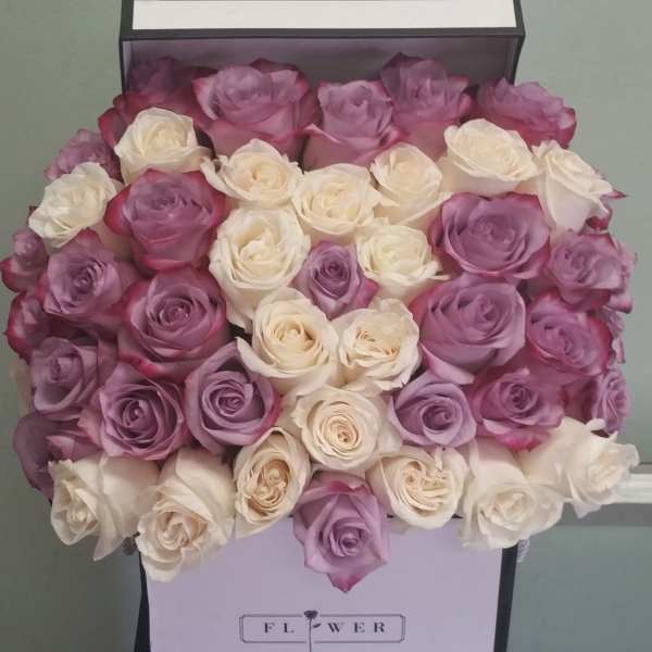 Boxed bouquet of pink, lavender, and white roses