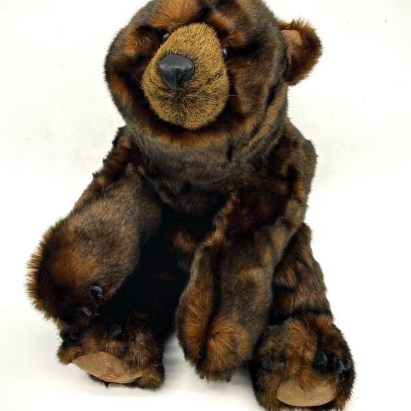Brown plush teddy bear sitting on a white background