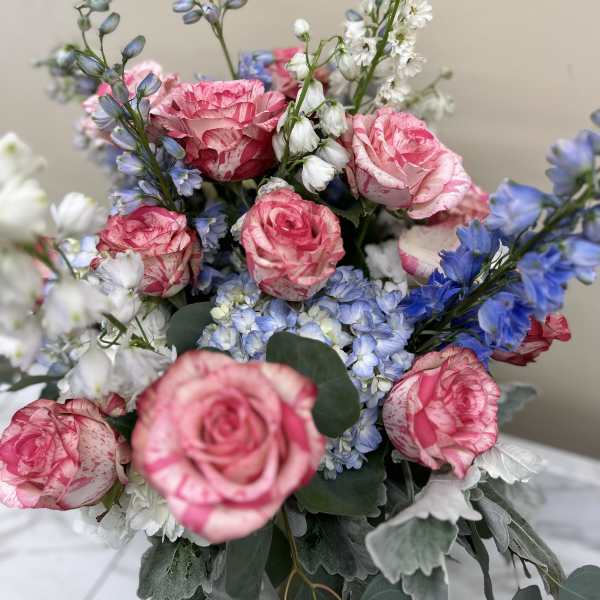 Bouquet of pink roses with blue and white flowers