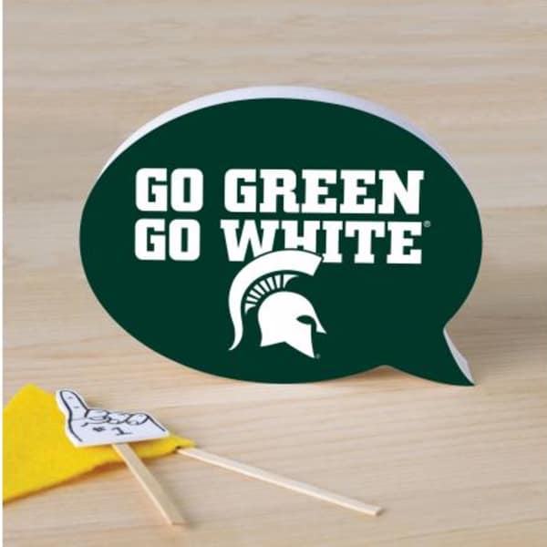 Green speech bubble sign with white text and a small yellow pennant