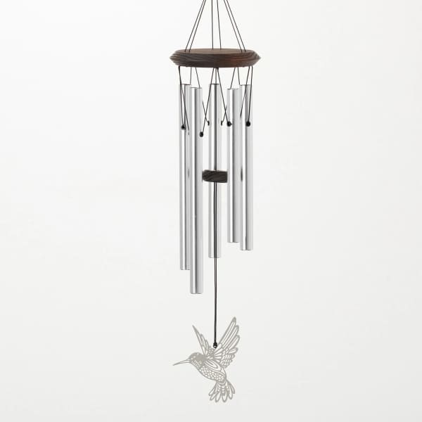Silver wind chime with a hummingbird ornament hanging from a dark top frame