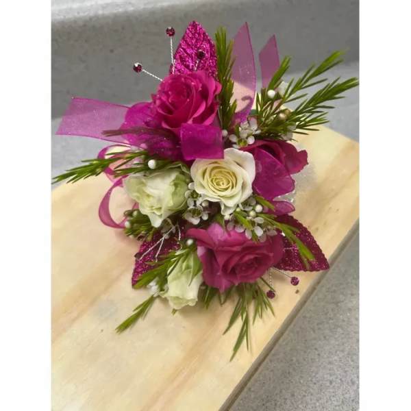 Pink and white rose corsage with glittery ribbon accents