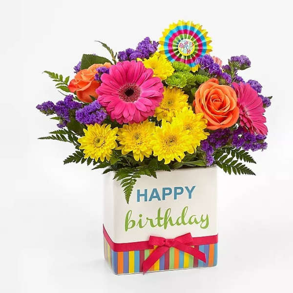 Bright mixed bouquet in a birthday gift box with a ribbon