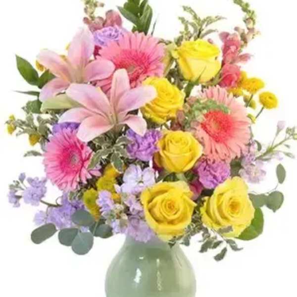 Mixed bouquet of pink, yellow, and purple flowers in a green vase