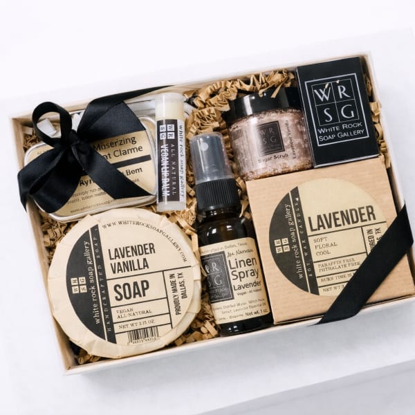 Gift box with lavender soap, spray, scrub, and balm tied with black ribbon
