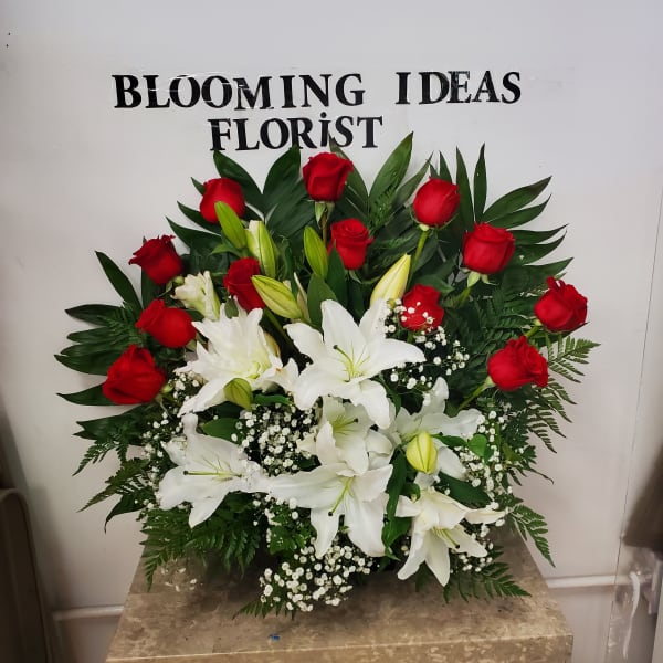 Red roses and white lilies arranged in a lush bouquet