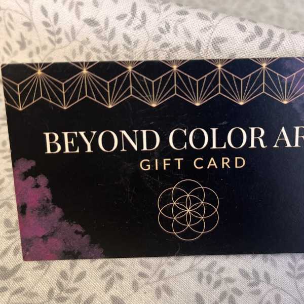 A Beyond Color Art gift card on patterned fabric