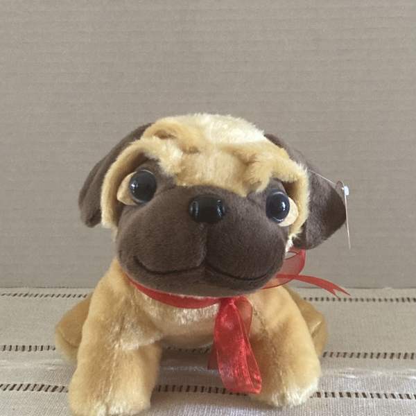 Plush pug toy with a red ribbon around its neck
