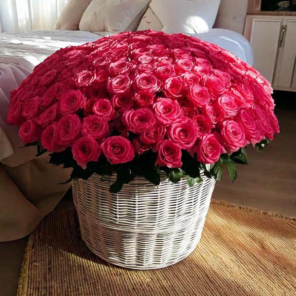 Large basket of bright pink roses on a bed