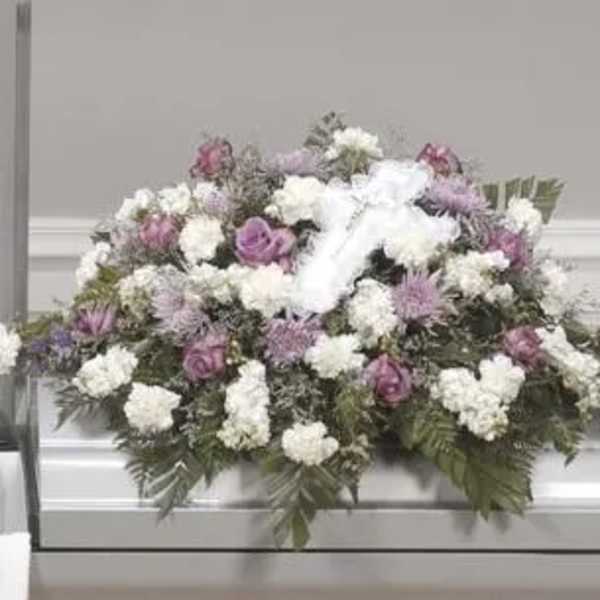 White and lavender funeral spray with roses and carnations