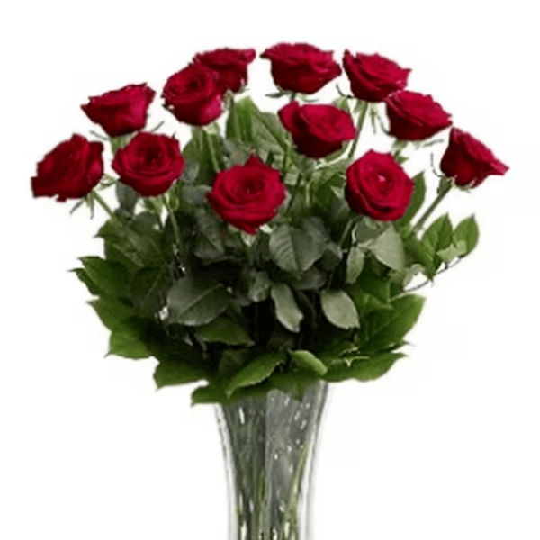Red roses arranged in a clear glass vase